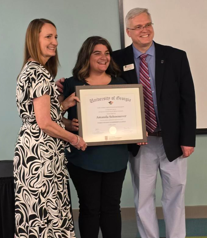 From left to right, UGA Institute of Government’s Tracy Arner, Fayette County Assistant Chief Financial Officer Amanda Schoonover and Institute of Government’s John Hulsey pose at the PFLA graduation ceremony. Photo courtesy of Amanda Schoonover.