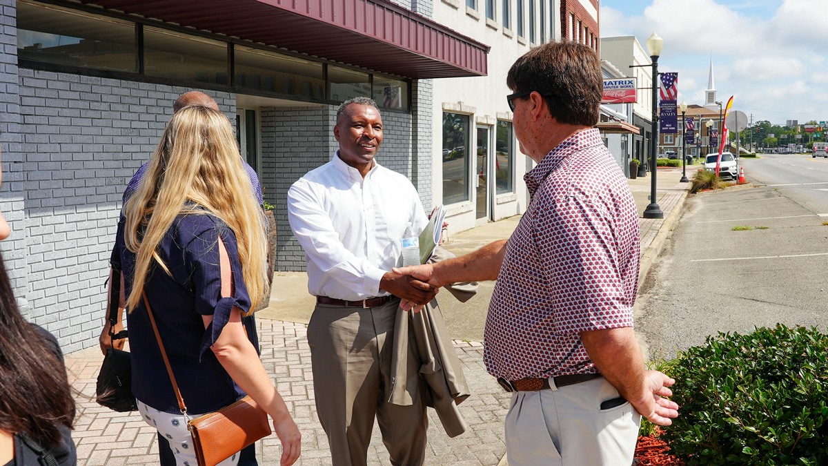 USDA Undersecretary for Rural Development Basil Gooden shakes hands with Steve Blackburn in downtown Baxley.