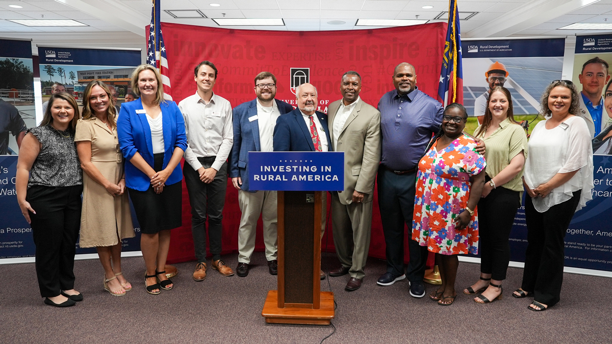 From left to right, Madison Drummond, Lauren Poe, Kristen Miller, Joe Barbaree, Greg Wilson, Tim Varnadoe, Basil Gooden, Reggie Taylor, Santina Fryer, Kira Greenfield and Amy Wilkie pose before a walking tour of downtown Baxley.