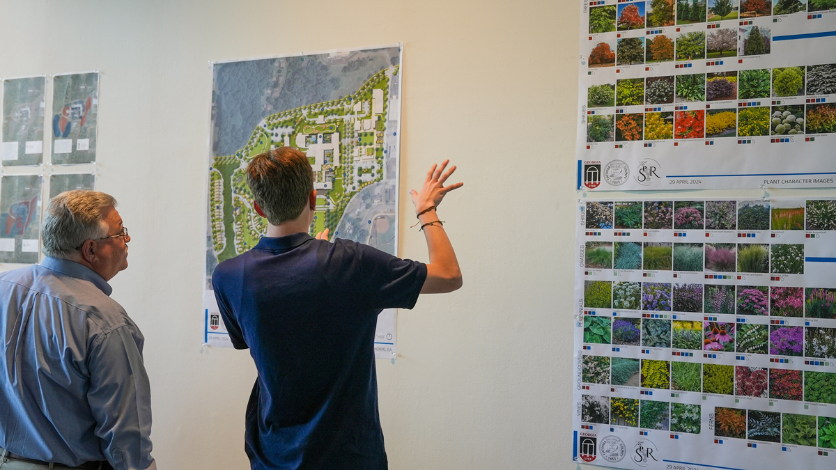 Catoosa County Manager Dan Wright listens as a student discusses a proposed planting plan. (Photo by Sara Ingram)