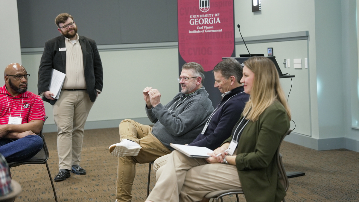 Keith Turman, left, and the institute’s Greg Wilson listen as Jonathan Jackson, Tim Powers and Keri Orvin share their communities’ experiences in PROPEL as part of a panel discussion. (Photo by Sara Ingram)