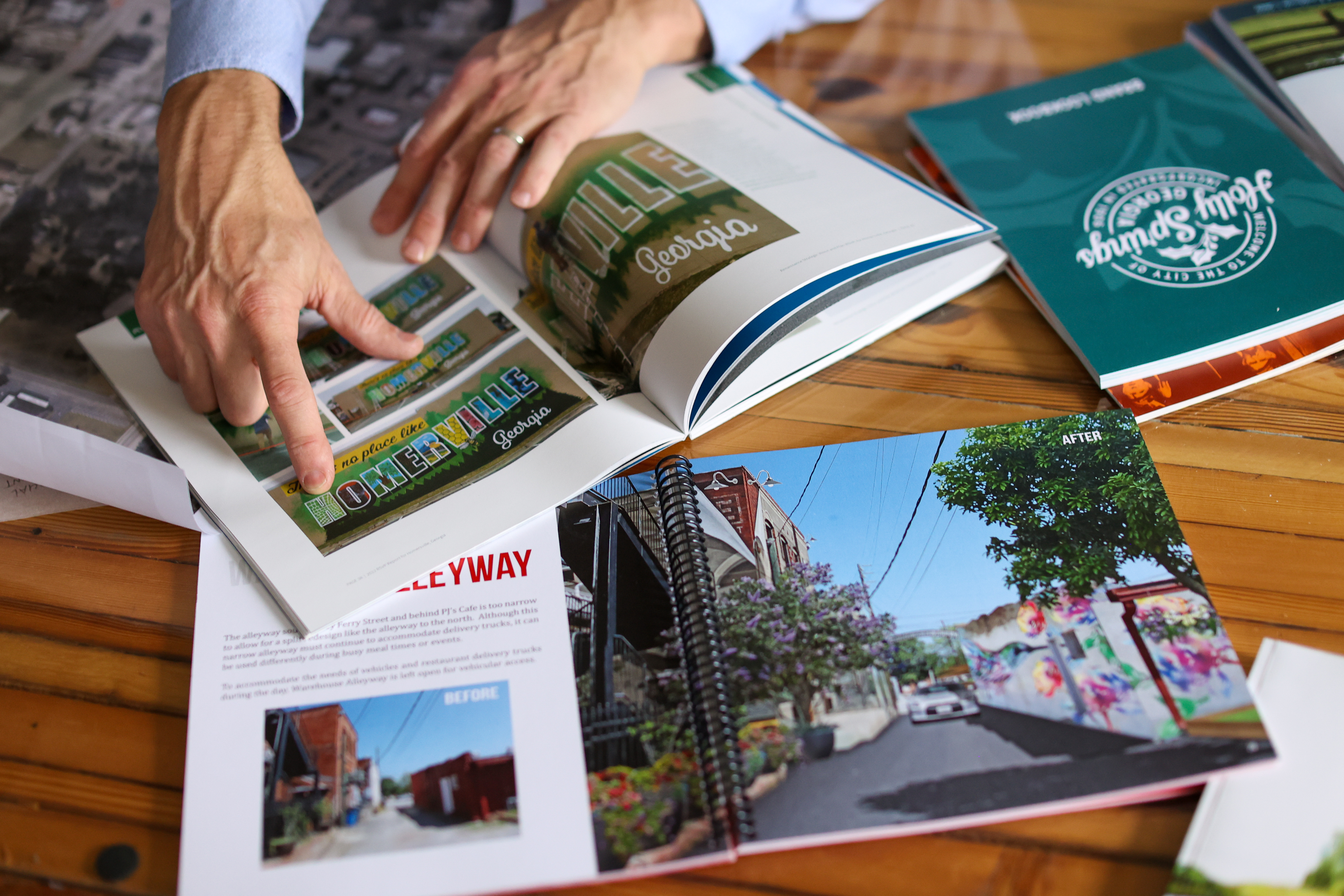 Lookbooks are spread across a table.