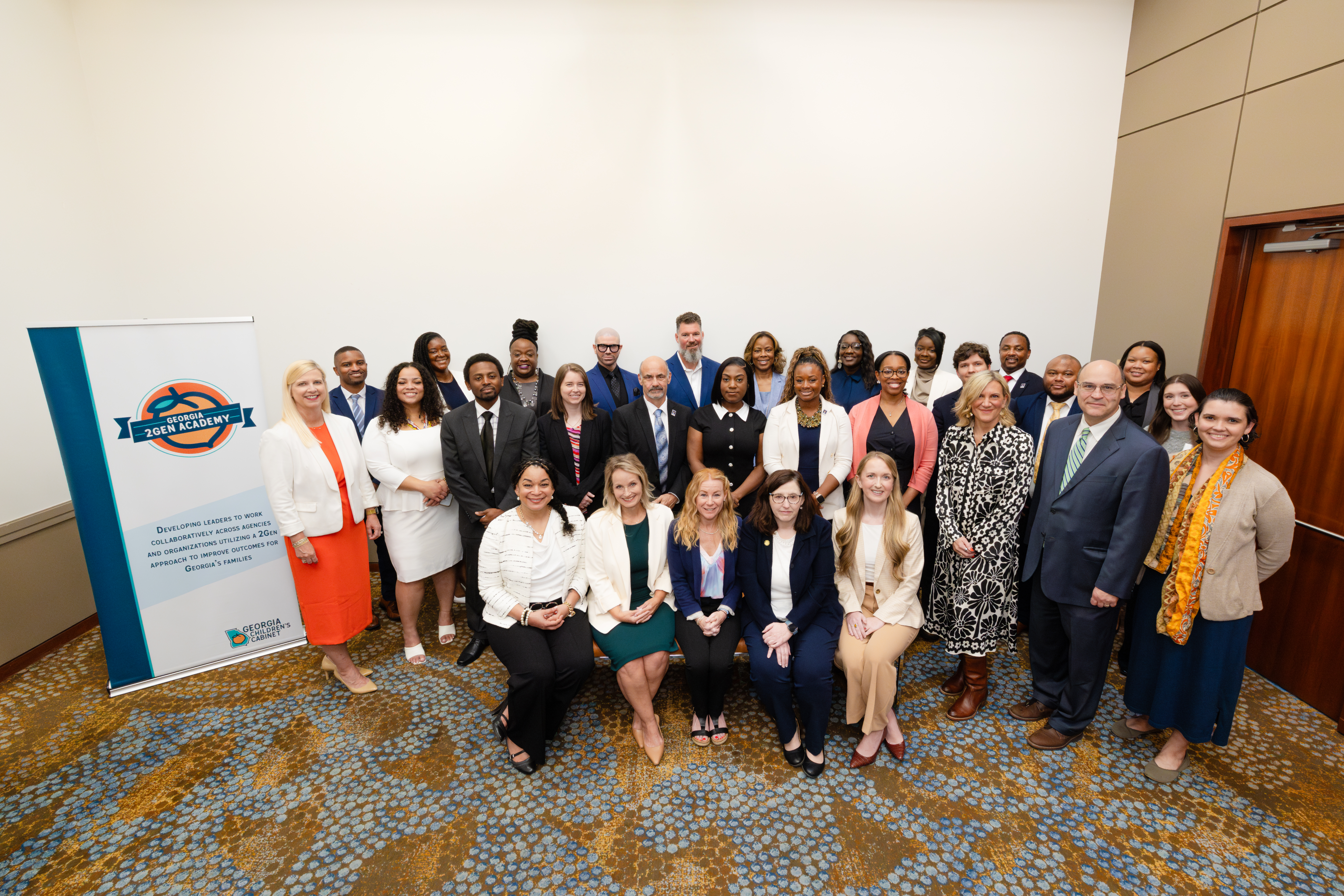 Recent graduates of the Georgia 2Gen Leadership Academy pose with Georgia Department of Early Care and Learning Commissioner Amy Jacobs (left) and UGA Institute of Government representatives Melinda Moore, David Tanner, Malisia Taylor, Elizabeth Bocz and Veronica Lopez-Delgado following the program's graduation ceremony. Photo by Casey Sykes. 