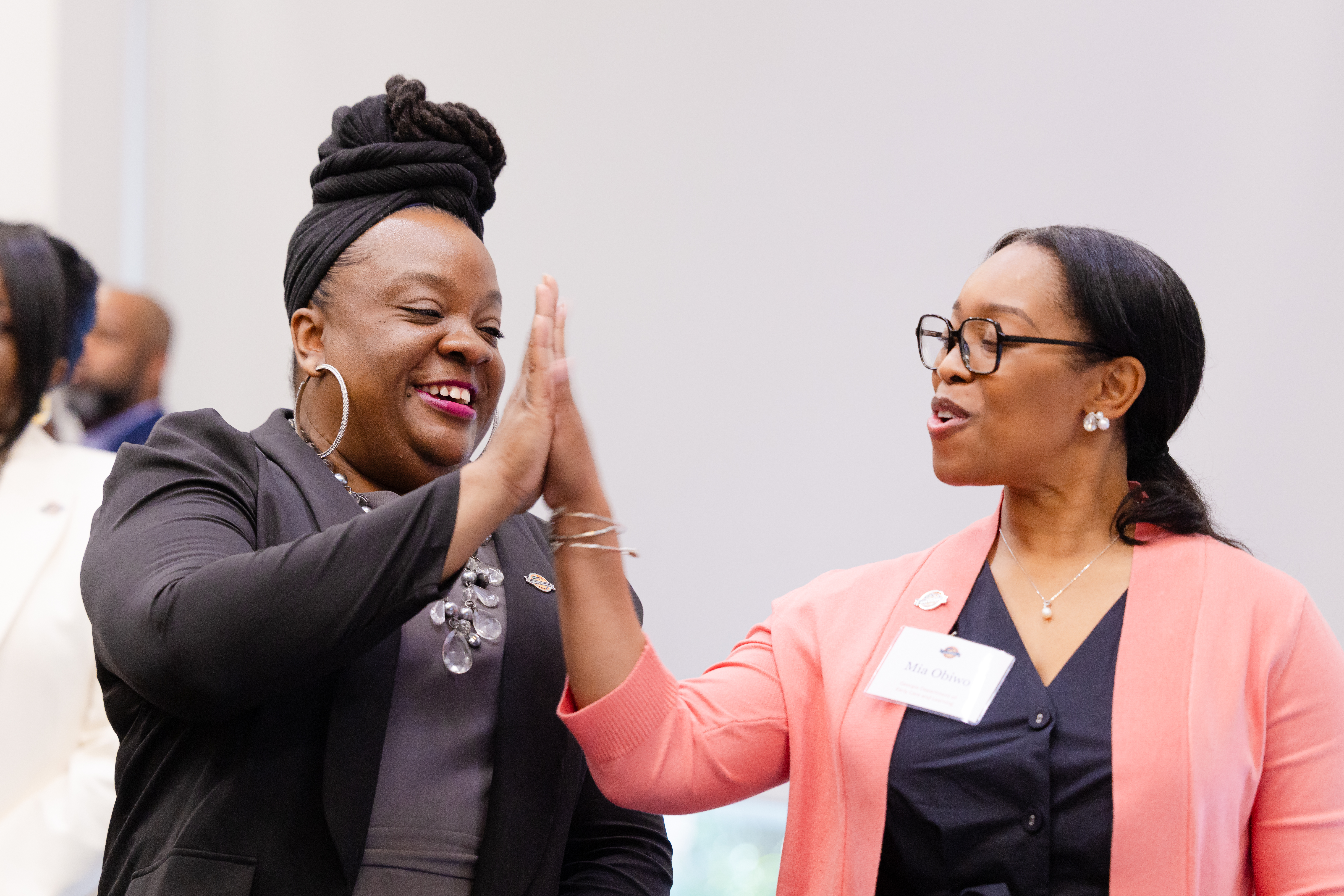 At left, Danyell Buford, United Way of Greater Atlanta Strong Learnings Program manager, and Mia Obiwo, Georgia Department of Early Care and Learning Workforce Policy and Process administrator, celebrate with a high five. Photo by Casey Sykes. 