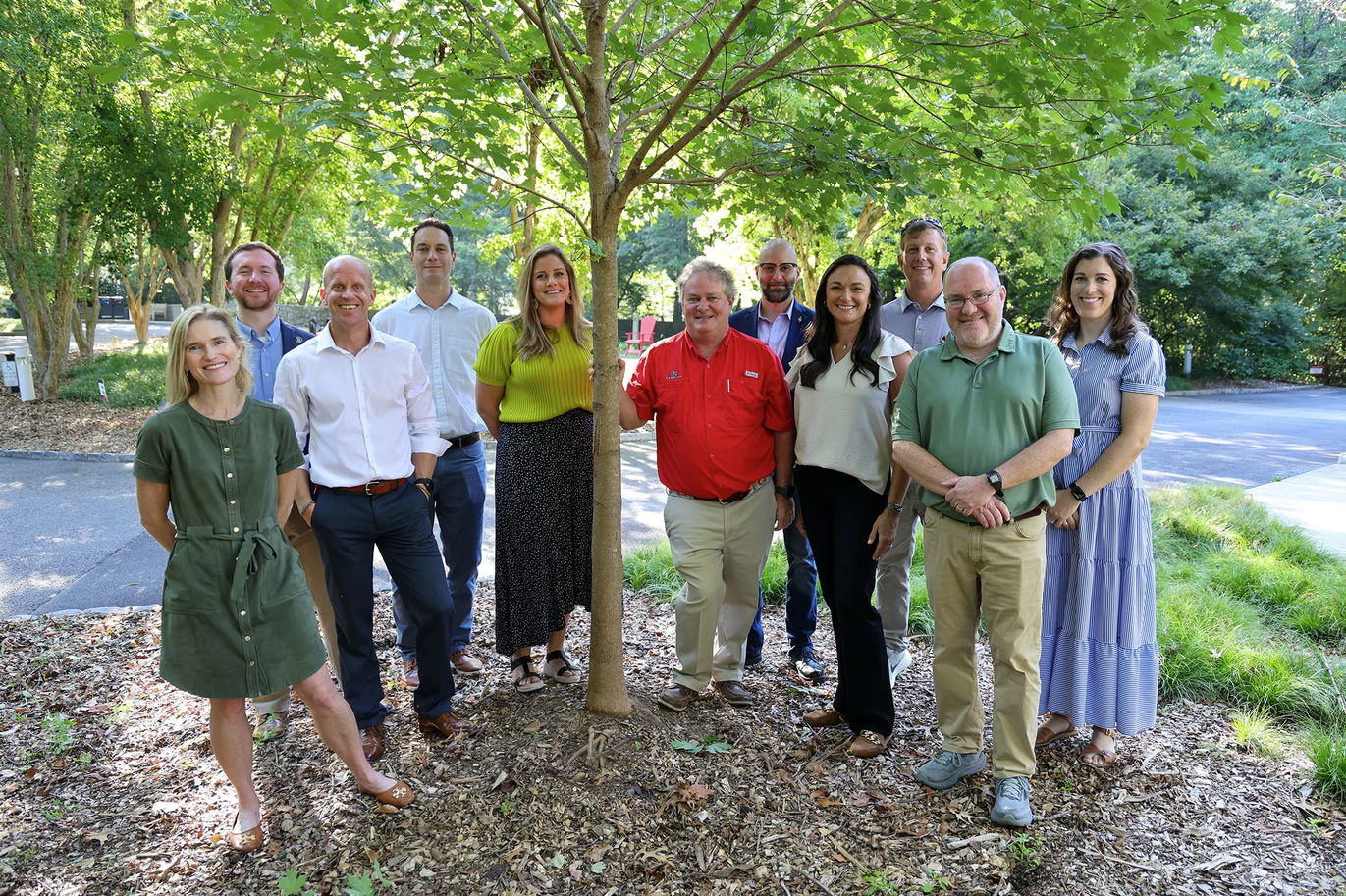 Group shot of Institute staff next to a replanted tree in support of canopy lost to Hurricane Helene