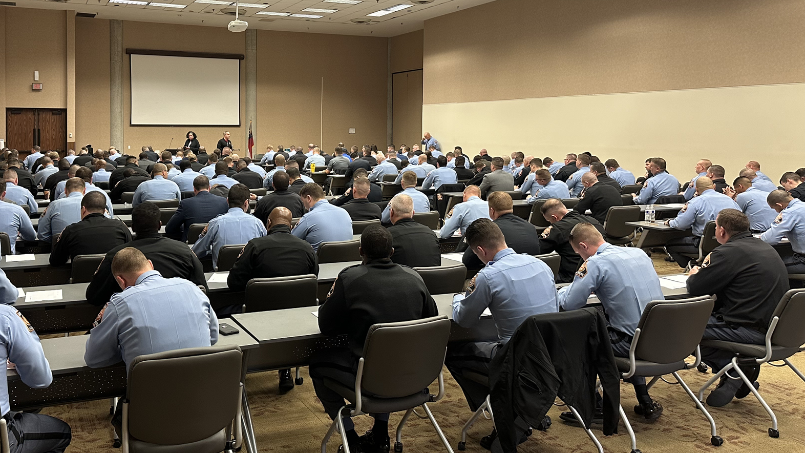 picture of patrol officers sitting in a large room for an assessment