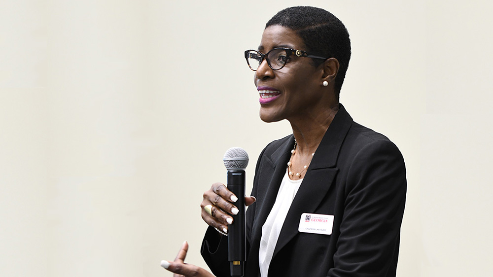 Woman leading discussion with microphone in hand